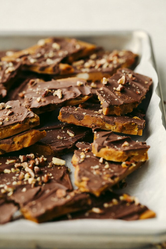 Homemade toffee is super simple with no candy thermometer required! This buttery chocolate treat is a must-make recipe this holiday season! Toffee broken up into multiple pieces.