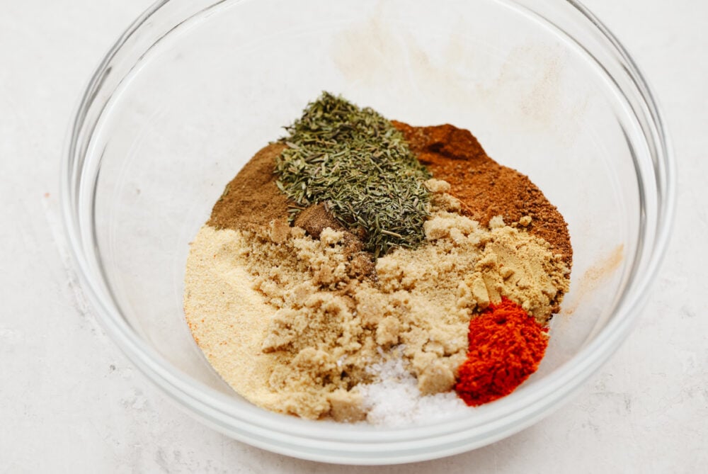 Jerk seasoning is the most deliciously sweet and savory blend of spices! It's simple to use and even more easy to make! You will have yourself a custom homemade seasoning in less than 5 minutes! A bowl showing an array of spices ready to be mixed.