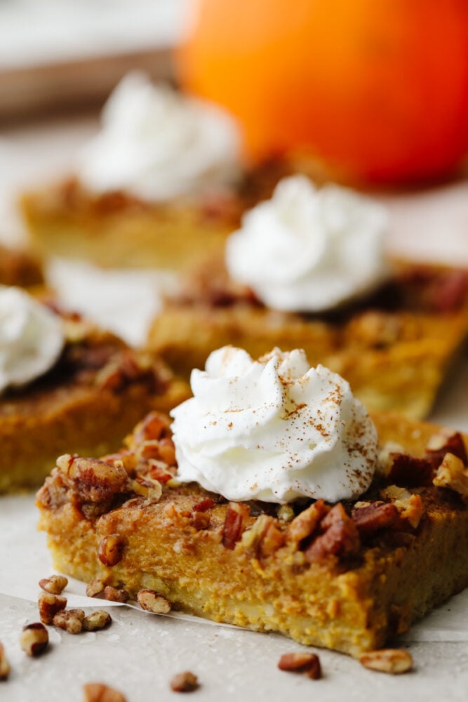 All of the goodness of fall treats combine in these delicious pumpkin pecan pie bars. Layers of shortbread, pecan, and spiced pumpkin will have you hooked!