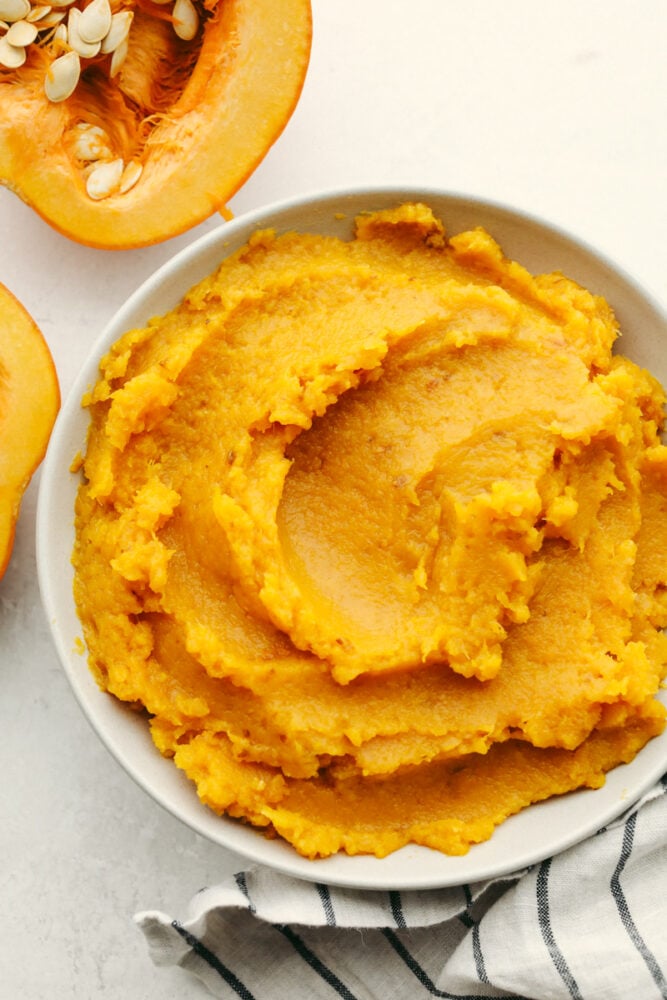 Pumpkin puree that is homemade cannot be beat! With its fresh taste and amazing texture, once you have tried this you will never go back! It is perfect for all of your fall recipes! Pumpkin puree in a bowl.