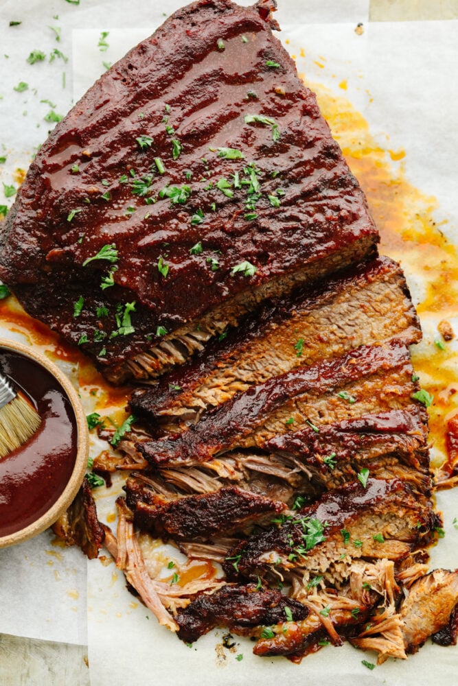 This Slow Cooker Beef Brisket is melt-in-your-mouth tender, packed with flavor, and practically cooks itself. Perfect for easy family dinners or feeding a hungry crowd! A beef brisket sliced on a platter.