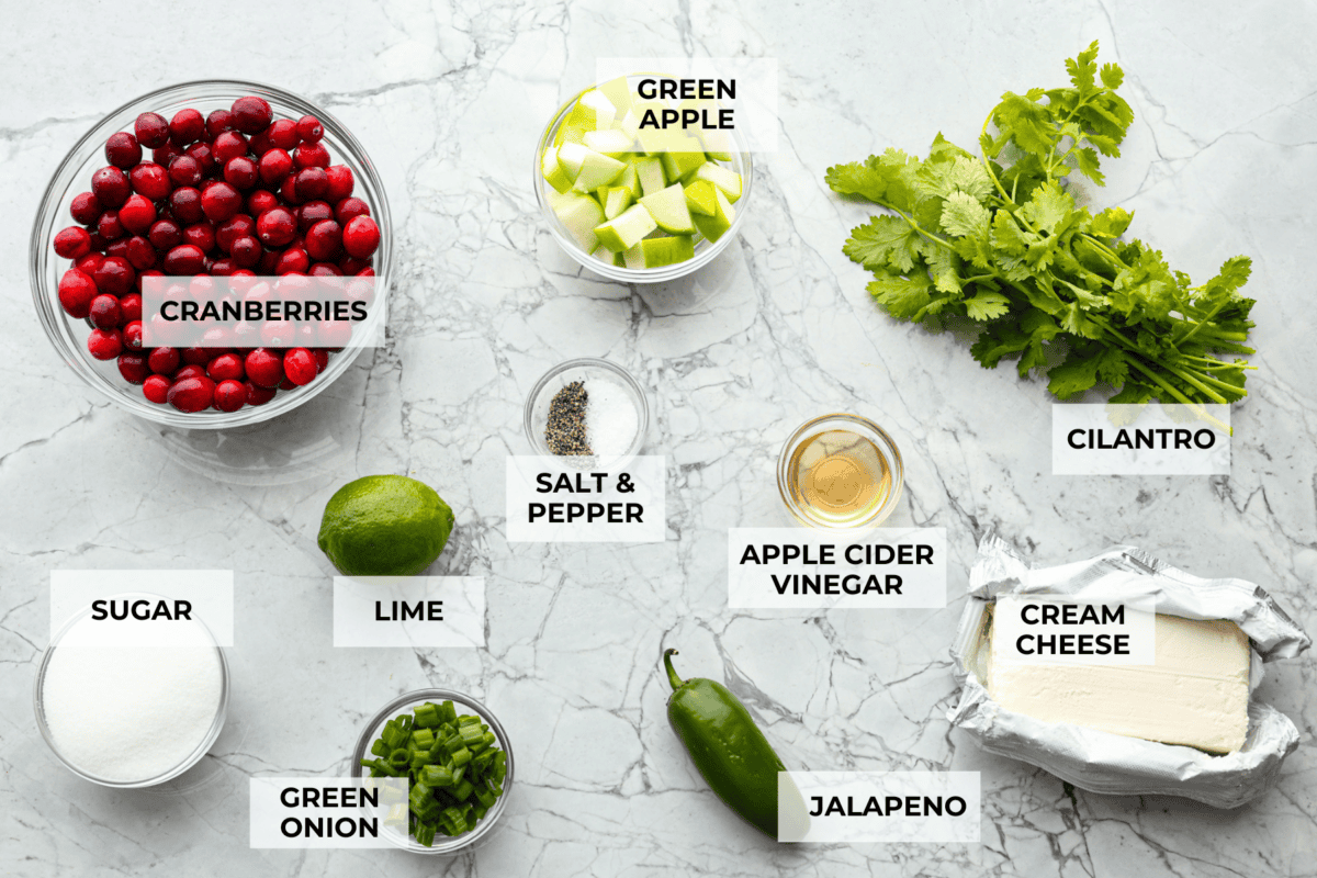 Cranberry salsaย is a fresh cranberry mixture of sweet and savory that is laid over cream cheese. It makes for the BEST holiday appetizer! You can also serve it in place of cranberry sauce with your Thanksgiving dinner. Overhead shot of labeled ingredients.