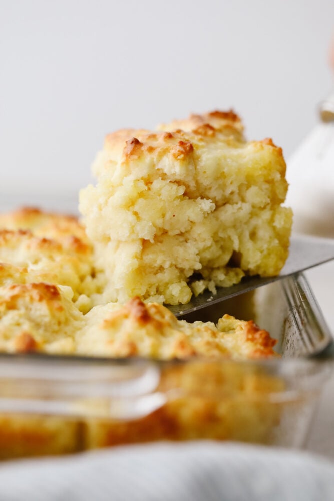 These swim butter biscuits are soft and fluffy on the inside with a crisp outside edge. They are SOO GOOD and will go with just about anything! A biscuit being served out of the pan.