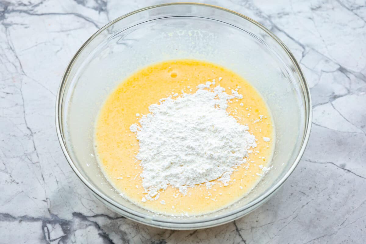 Corn pudding is creamy, slightly sweet, with a hint of savory! It's packed with cream, butter, sweet and juicy corn kernels, all baked to perfection. It will be an awesome addition to your Thanksgiving spread, or make it for any weeknight. Overhead shot of eggs with cornstarch mixture.