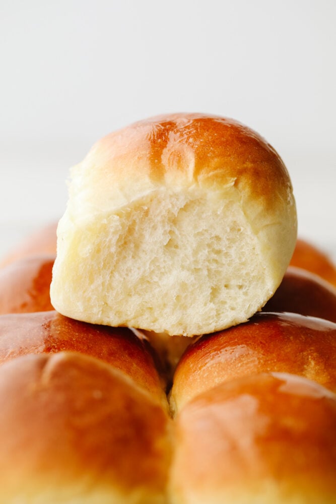 These 1-hour dinner rolls are the perfect solution for making fresh bread in a pinch! This easy and delicious roll recipe will become your new favorite, just in time for the holidays! Rolls stacked on top of each other.