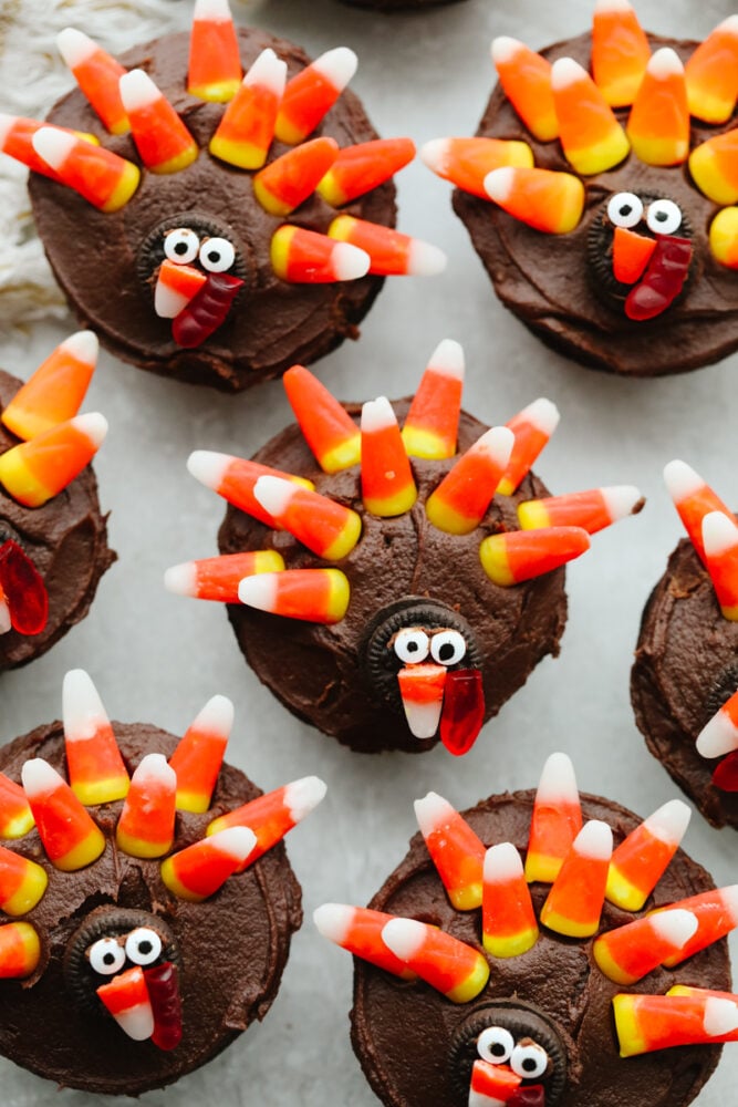 These turkey cupcakes are cute, festive, and oh so delicious! Your kids will love making these and they are perfect for the Thanksgiving season! A few turkey cupcakes on the counter.
