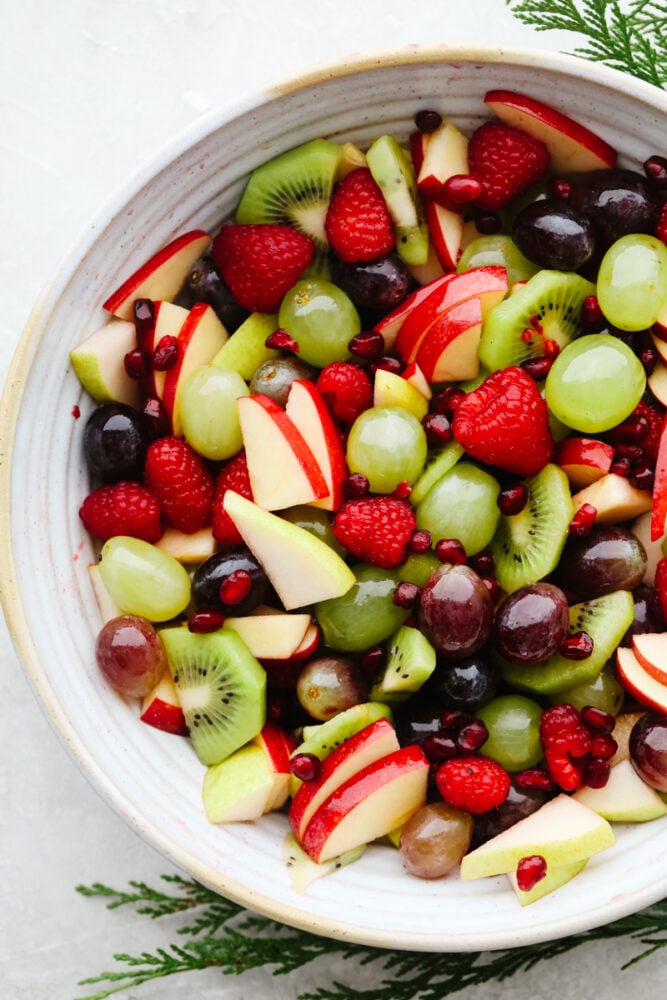 This easy Christmas fruit salad recipe is loaded with red and green fruit making it the perfect light and healthy addition to your holiday table! With a super simple dressing, it comes together quickly and is sure to be a hit! A bowl of mixed fruit.