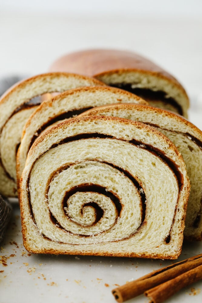 This bread not only tastes amazing but those thick cinnamon swirls make it gorgeous enough to impress any guest! WIth the perfectly golden outside and delicious cinnamon flavor on the inside, you will come back to this again and again! Cinnamon swirl bread all sliced up.