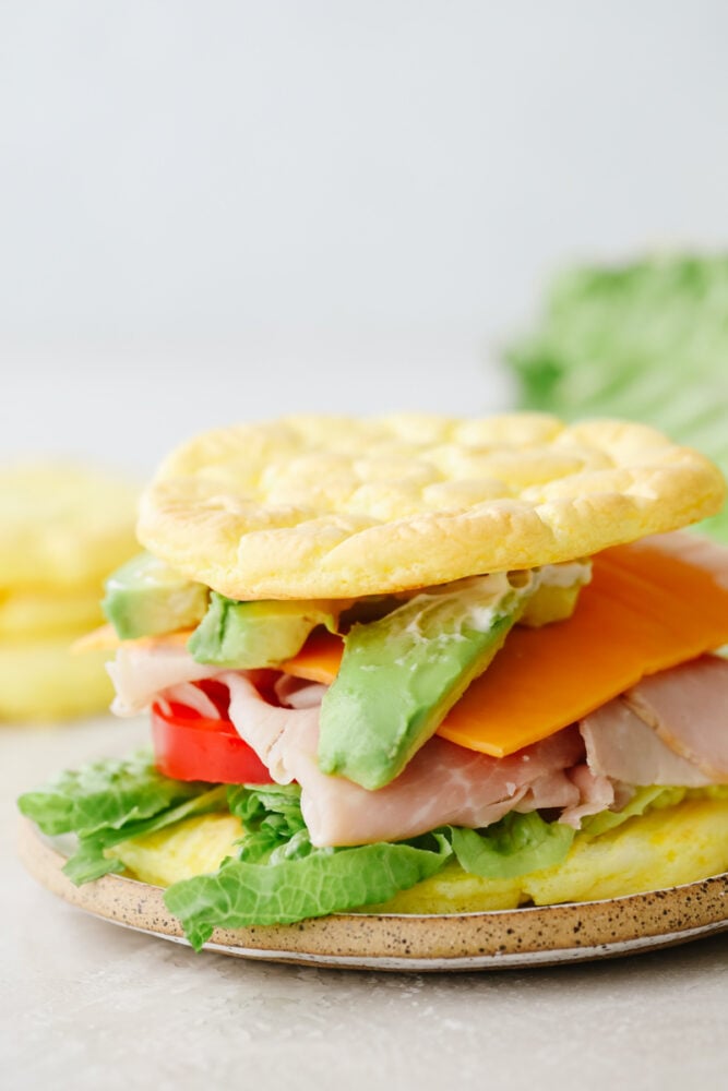 Whipped and airy, this cloud bread really fits its name! It's so delicious and savory that it goes with just about everything. Bake this up and watch it fly off of your table! A sandwich made with cloud bread.
