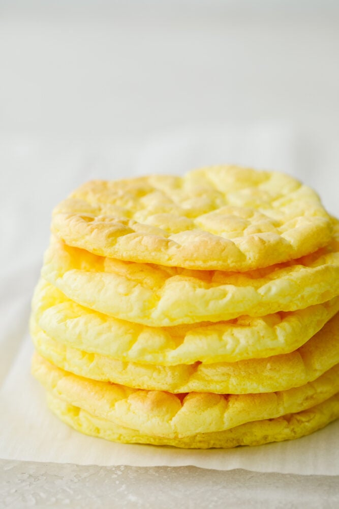 Whipped and airy, this cloud bread really fits its name! It's so delicious and savory that it goes with just about everything. Bake this up and watch it fly off of your table! A stack of cloud bread.