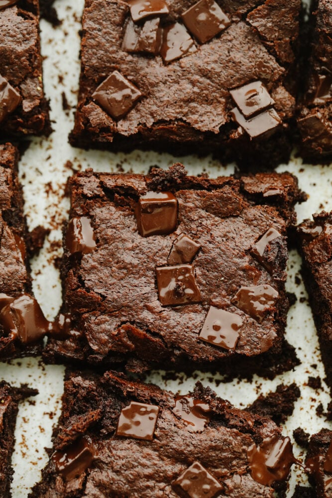 These flourless chocolate brownies are absolute heaven! The thin, chewy texture and sweet flavor are so delicious that I bet that you can't just stop at one! A zoomed in shot of 2 flourless chocolate brownies.