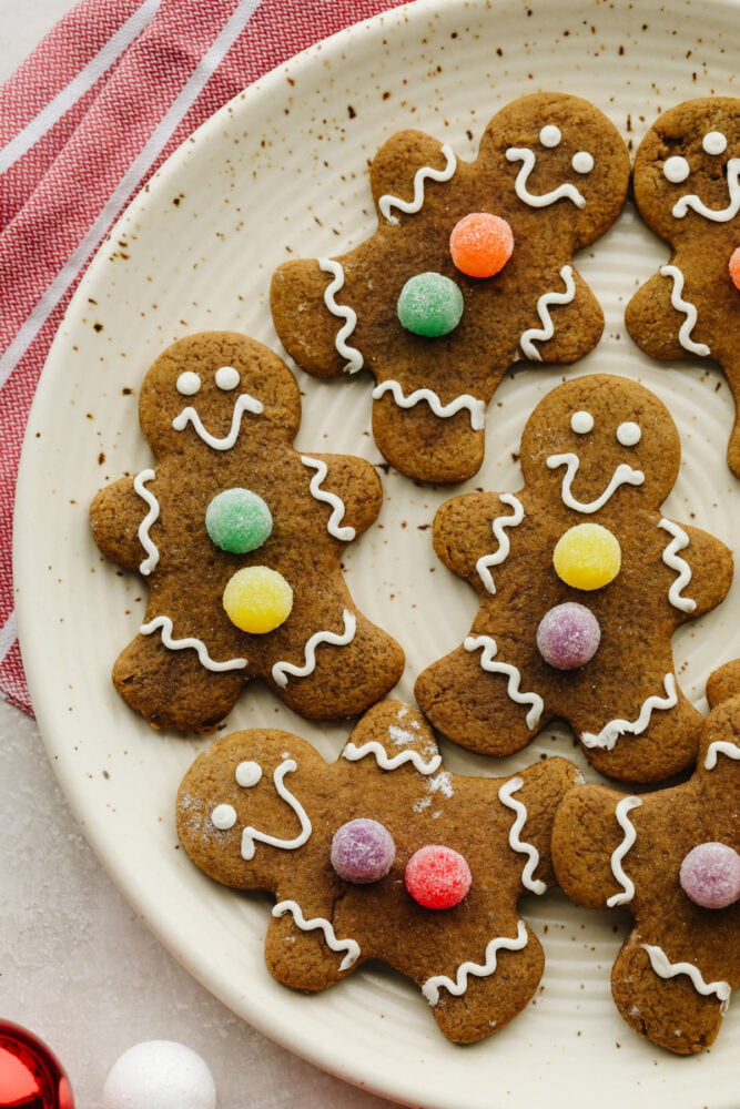 Soft and chewy gingerbread cookies are my favorite Christmas treat to decorate with my kids. They're just as delicious to eat as they are cute to look at! Gingerbread cookies on a plate.