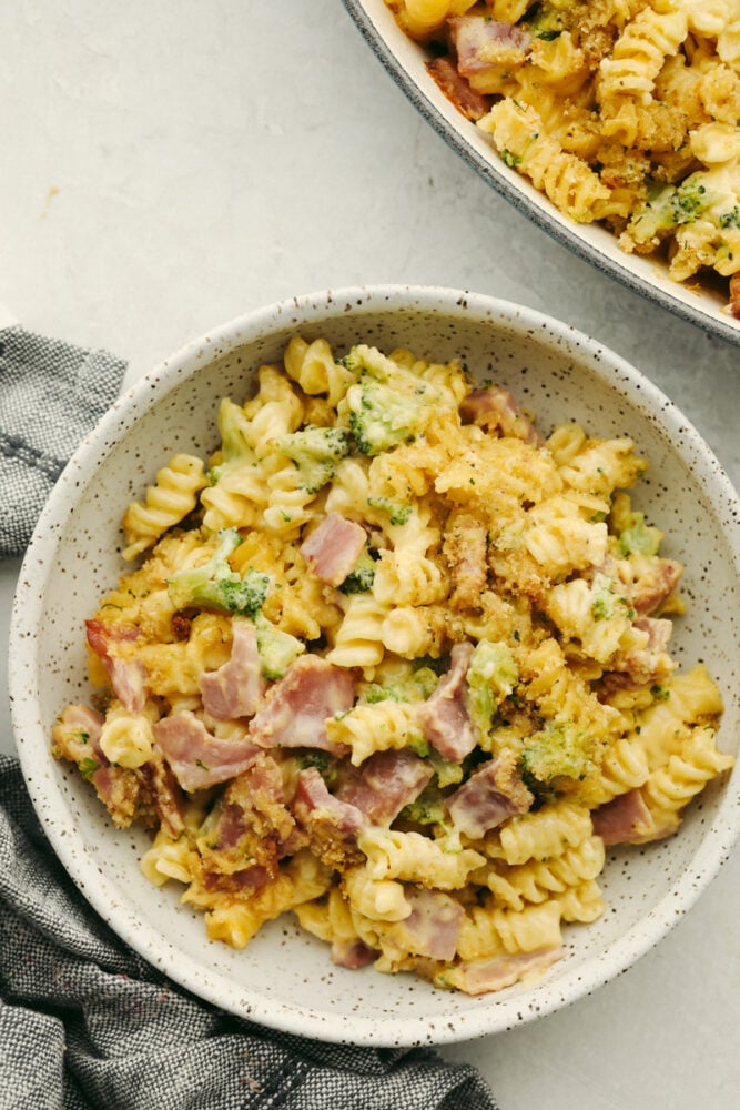 If you have leftover ham from your holiday dinner then this cheesy ham casserole is for you! Delicious noodles topped with cheese sauce, ham, broccoli, and crispy bread crumbs, this dish will be a family favorite! Cheesy ham casserole in a bowl, ready to eat.