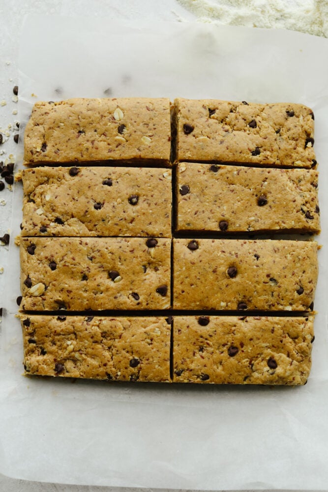 These healthy and easy to put together protein bars are the perfect snack to start the year off right! It's so simple and delicious, you will never buy them from the store again! 8 protein bars in a row cut and ready to eat.