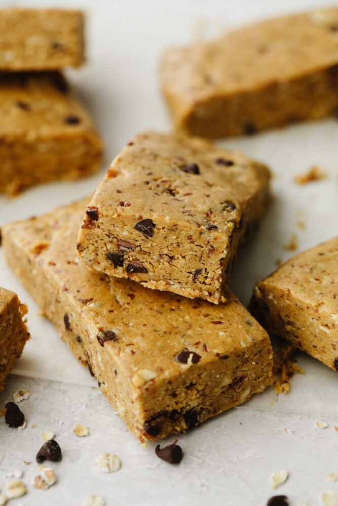 These healthy and easy to put together protein bars are the perfect snack to start the year off right! It's so simple and delicious, you will never buy them from the store again! A stack of protein bars.
