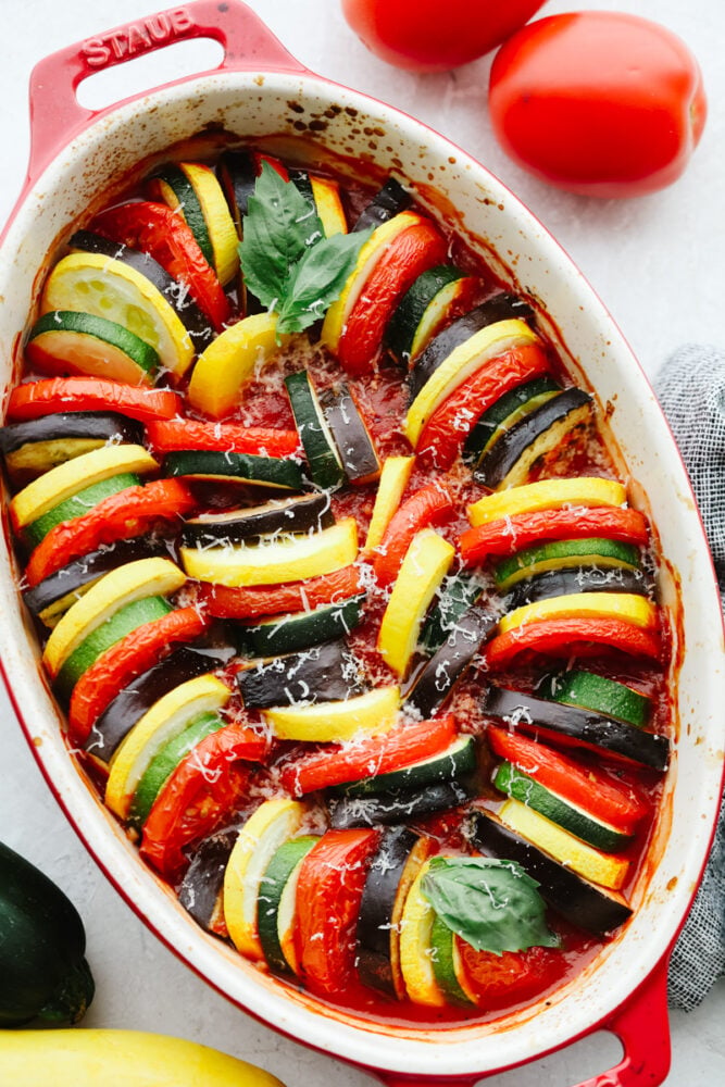 This ratatouille is made up of delicious sliced vegetables that are seasoned to perfection and cooked in a delicious sauce. It's so good that you will want to add it as a side to every meal! A baking dish filled with baked ratatouille.