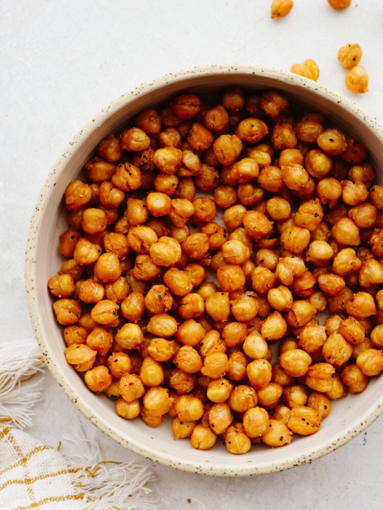 Air fryer chickpeas are crispy and flavored to perfection! With three different ways to season them, there will be a flavor for everyone. These crunchy, roasted chickpeas will become your new go-to snack! Air fryer chickpeas in a bowl.