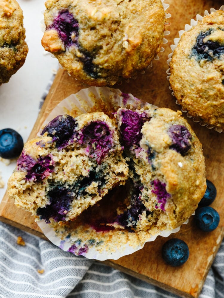 These blueberry oatmeal muffins are a healthy, hearty snack or breakfast loaded with whole grains and bursting berries! They're a delicious way to give you energy throughout your busy days! A blueberry oatmeal muffin torn in half.
