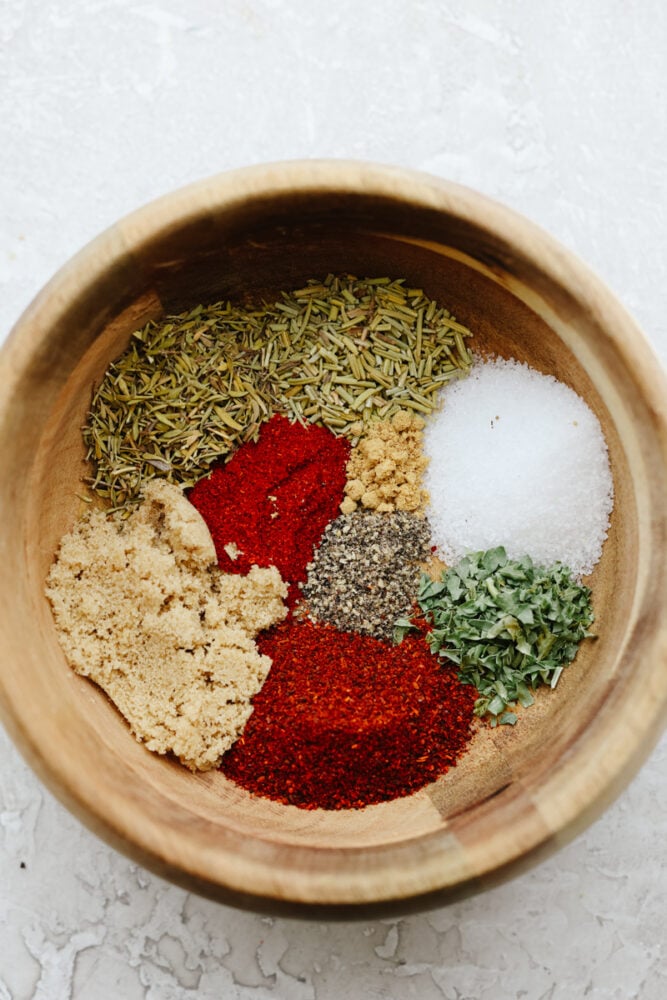 ade with delicious herbs and savory flavors, this chicken seasoning will make any piece of chicken taste absolutely incredible! It takes any chicken recipe to the next level. You will never buy store-bought seasoning again! A wooded bowl filled with seasonings ready to be mixed together.