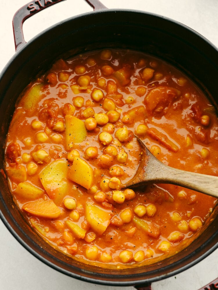 Chickpea curry is easy, healthy, and bursting with flavor! You'll be hooked after one bite of this hearty curry loaded with garlic, spices, and tender pieces of potato. Closeup of a pot of chickpea curry.
