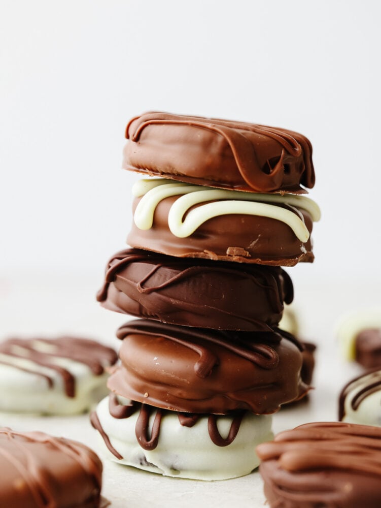 Add a layer of indulgence to a classic cookie with these chocolate covered Oreos! These little bites of chocolatey goodness are a crowd-pleaser wherever they go! A stack of 5 chocolate-covered Oreos.
