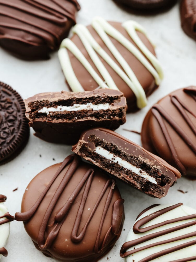 Add a layer of indulgence to a classic cookie with these chocolate covered Oreos! These little bites of chocolatey goodness are a crowd-pleaser wherever they go! Closeup of a chocolate covered Oreo broken in half.