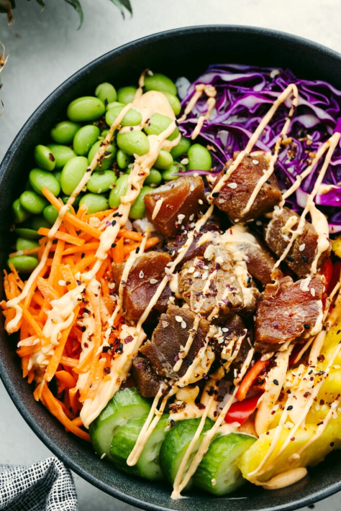 This Hawaiian poke bowl is fantastically fresh and full of healthy ingredients! Skip ordering this at a restaurant and make it at home in less than 15 minutes!ย A close up of a Hawaiian poke bowl.