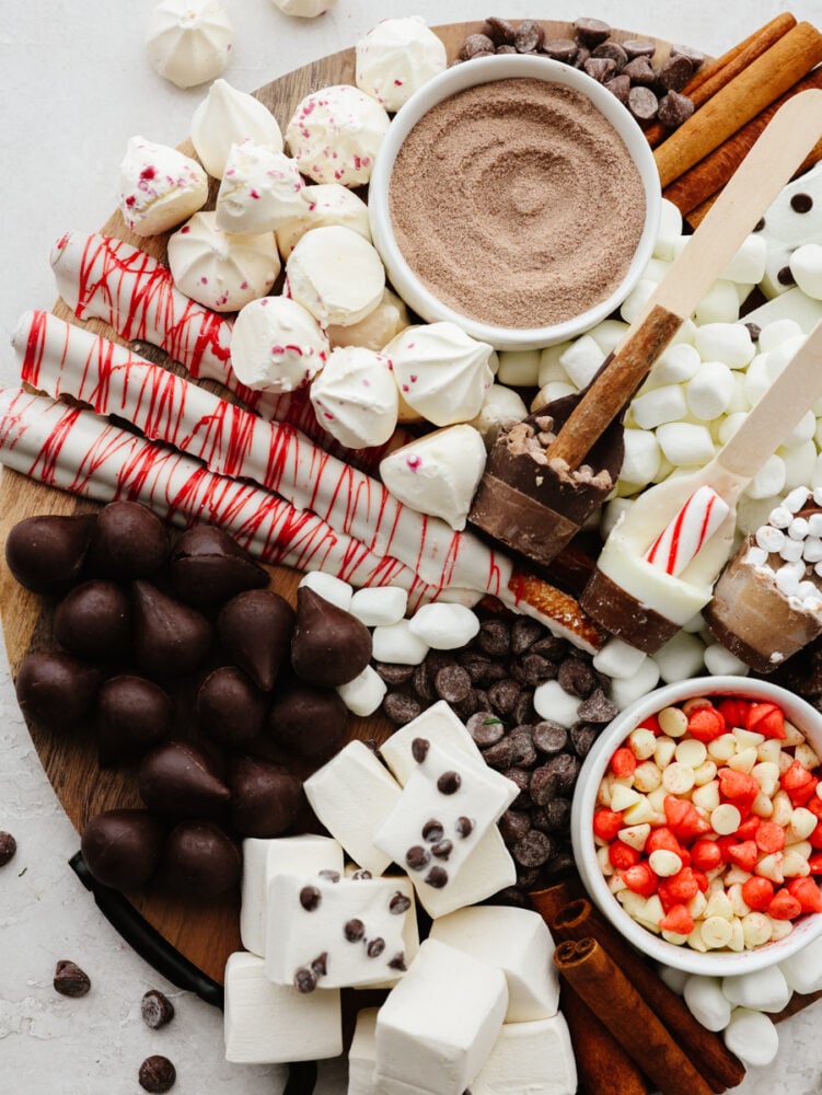 It doesn't get more fun than a hot chocolate charcuterie board! Filled with all of the delicious toppings and mix-ins that any hot chocolate lover will go crazy for, this board is for everyone! A zoomed in shot of a hot chocolate charcuterie board.