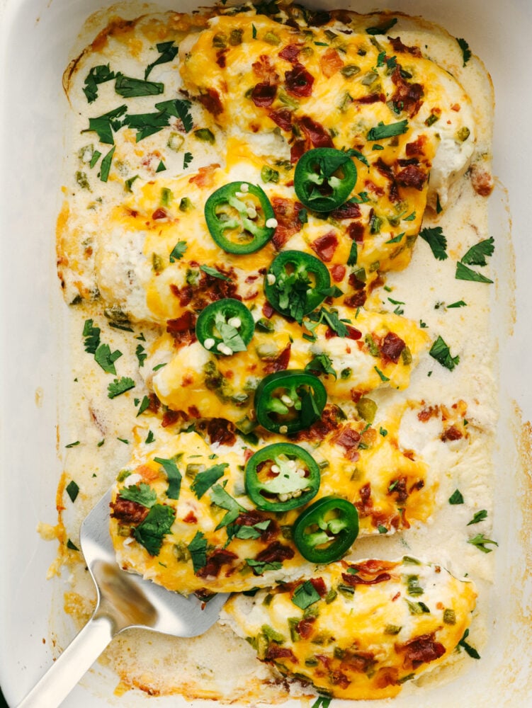 Dinnertime-ready, this jalapeno popper chicken is creamy and delicious with the perfect amount of heat! It has all of the flavors of your favorite appetizers, but in one easy-to-make meal! 5 baked chicken breasts covered in cheese and jalapenos.