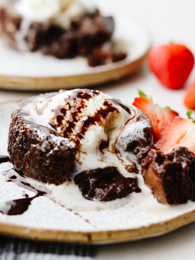 Chocolate lava cake is the ultimate dessert. It's a showstopper, moist cake that has an oozing chocolate center. Your guests will go crazy over this recipe! Chocolate lava cake with melted ice cream on top.