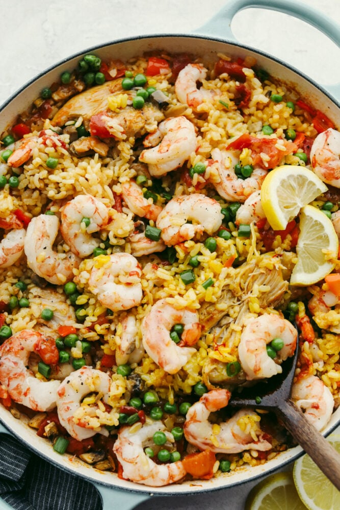 This chicken and shrimp paella is the perfect comfort food! Rich in flavor, this paella is so delicious that you won't be able to stop yourself from coming back for seconds! Chicken and shrimp paella in a skillet.