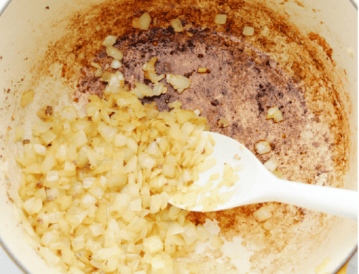 American Goulash is my kind of comfort food! It's rich, savory, and full of that cozy, tomato-y goodness. Itโs hearty, easy to make, and one bite will have you hooked just like my family is! Onions cooking with garlic in the pot