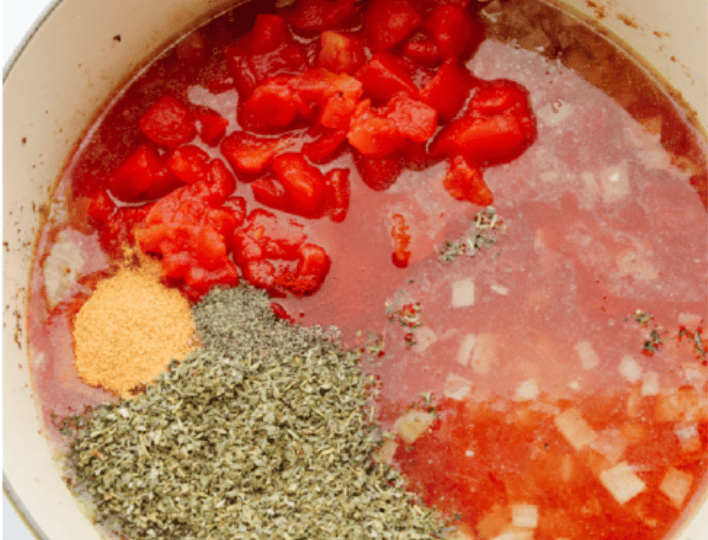 American Goulash is my kind of comfort food! It's rich, savory, and full of that cozy, tomato-y goodness. Itโs hearty, easy to make, and one bite will have you hooked just like my family is! Tomatoes, water, and seasonings added to the pot with the onions.