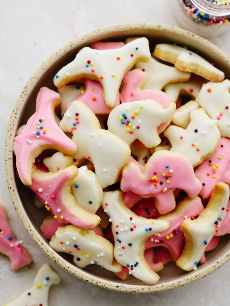 Forget buying these at the store... These circus animal cookies are way better when you make them at home! They are so delicious and bite-sized that they make the perfect treat for anyone, young and old! A gray, speckled bowl filled with circus animal cookies.
