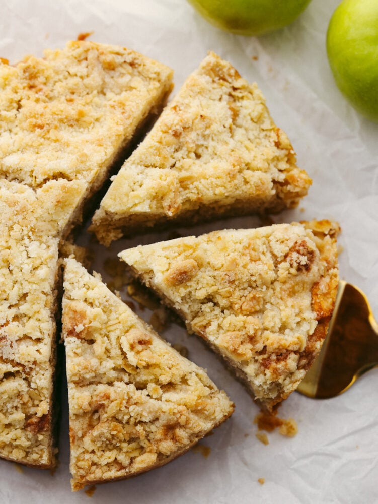 With a buttery streusel topping, Irish apple cake is tender and spiced to perfection. Drizzled with a warm custard sauce, this is one dessert you won't want to miss! An Irish apple cake cut into 3 pieces.