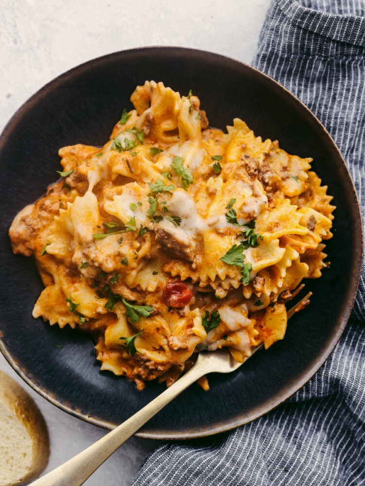 This Instant Pot recipe is filled with all the lasagna flavors you love! Layers of creamy ricotta, melty mozzarella, and ground beef seasoned with Italian herbs come together in this super easy dish! Lasagna on a black stoneware plate.