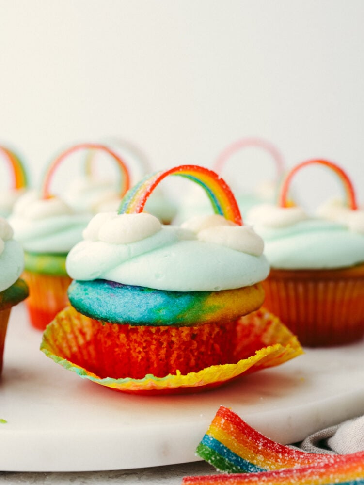 No need for a pot of gold when you’ve got these cupcakes around! These colorful rainbow cupcakes are perfectly moist, topped with the most amazing buttercream. They’ll light up any party! Rainbow cupcakes on a marble serving platter.