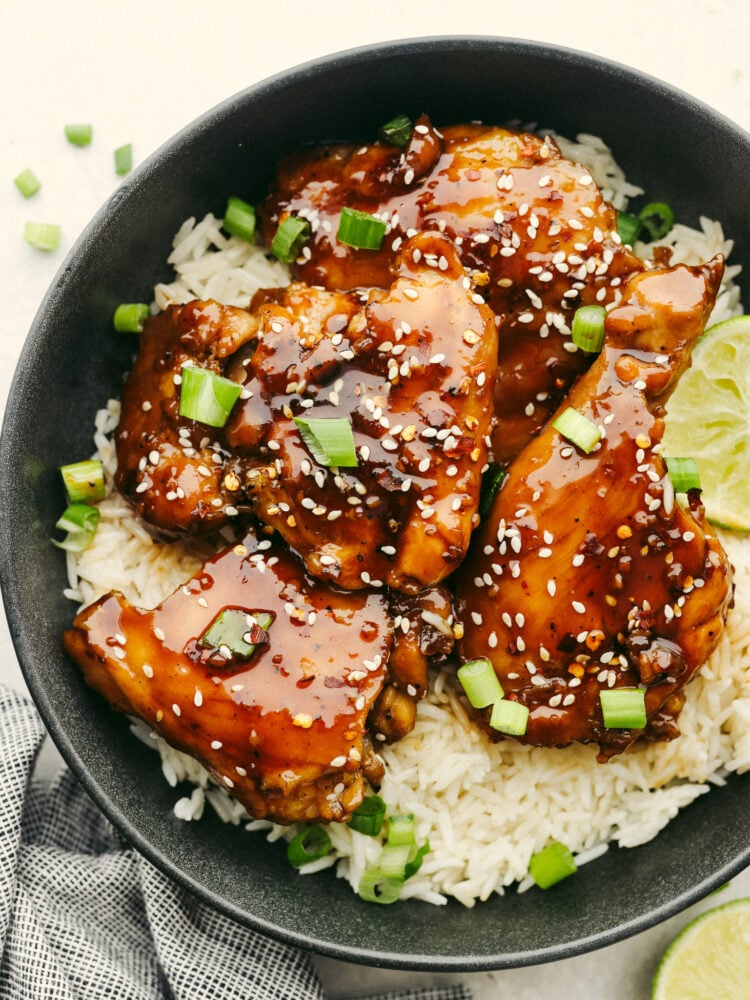 My Sticky Asian Glazed Chicken is one of those dinners I keep coming back to. Itโs sweet, a little savory, and full of flavorโbut honestly, itโs the caramelized glaze that seals the deal. It's SO GOOD! Plated sticky asian glazed chicken with rice and garnished with green onions.