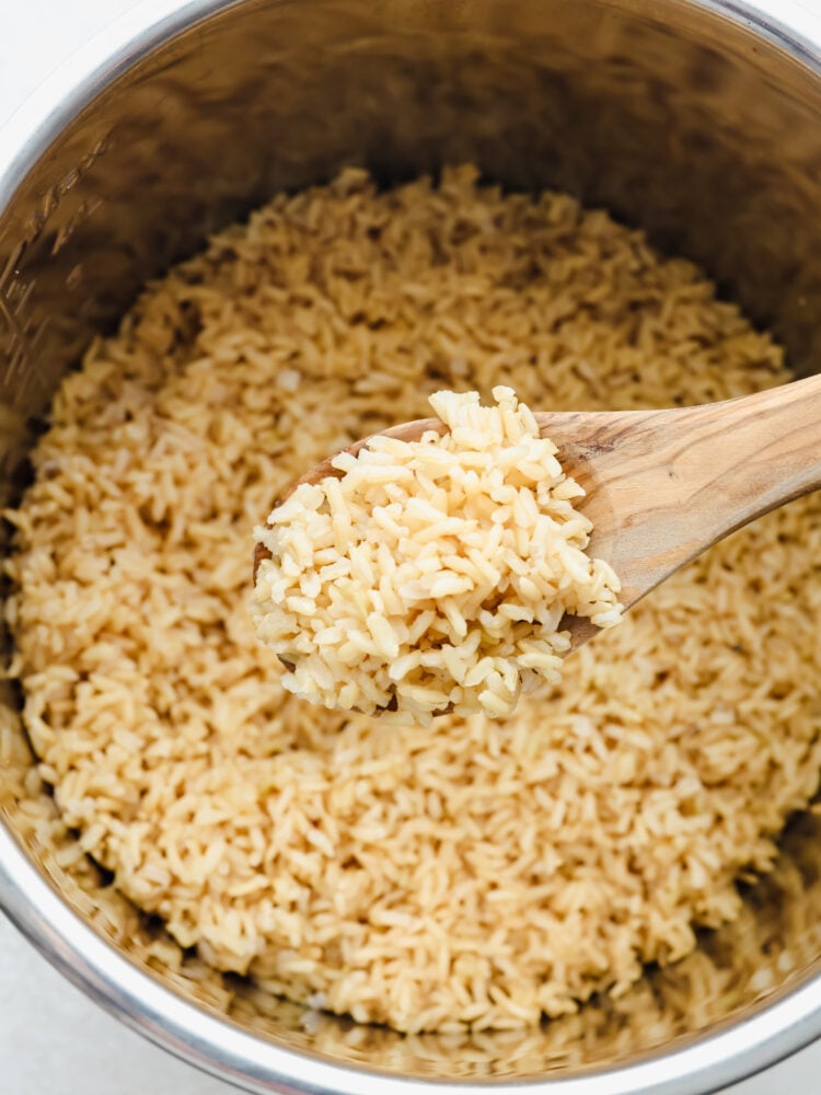 Brown rice can be tricky to get right. Make it in your Instant Pot and you'll have fresh, fluffy rice ready in 20 minutes! Closeup of a scoop of brown rice.