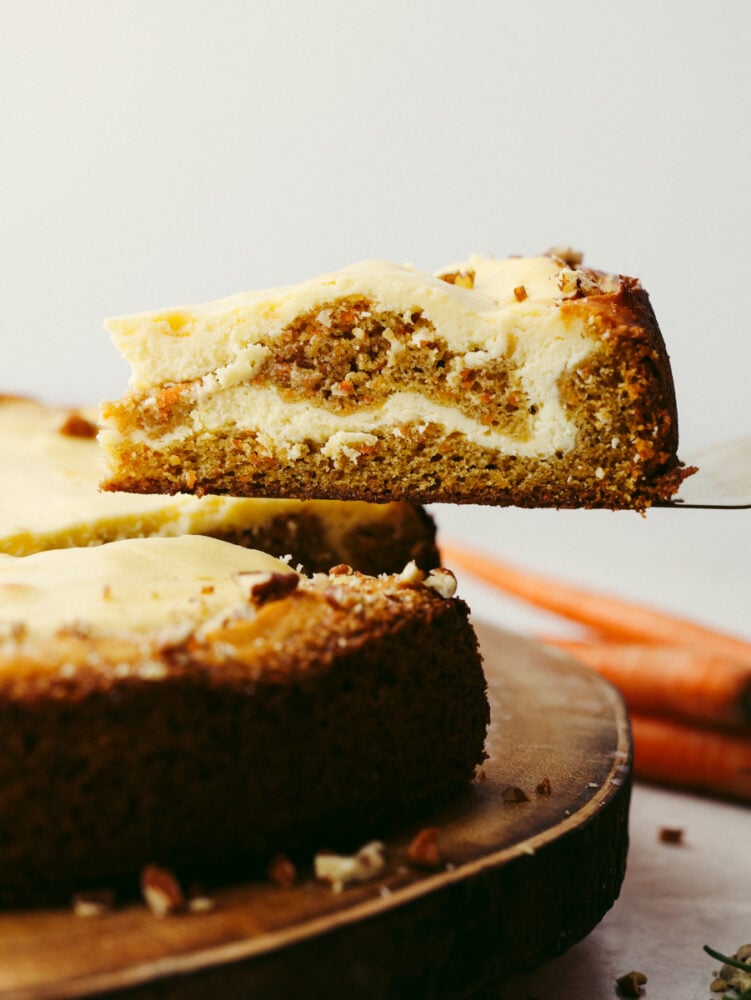 Nutty, sweet, and decadent, each bite of carrot cake cheesecake is a dream! This dessert is so good you wonโt want to stop at one piece! Taking a slice of carrot cake cheesecake.
