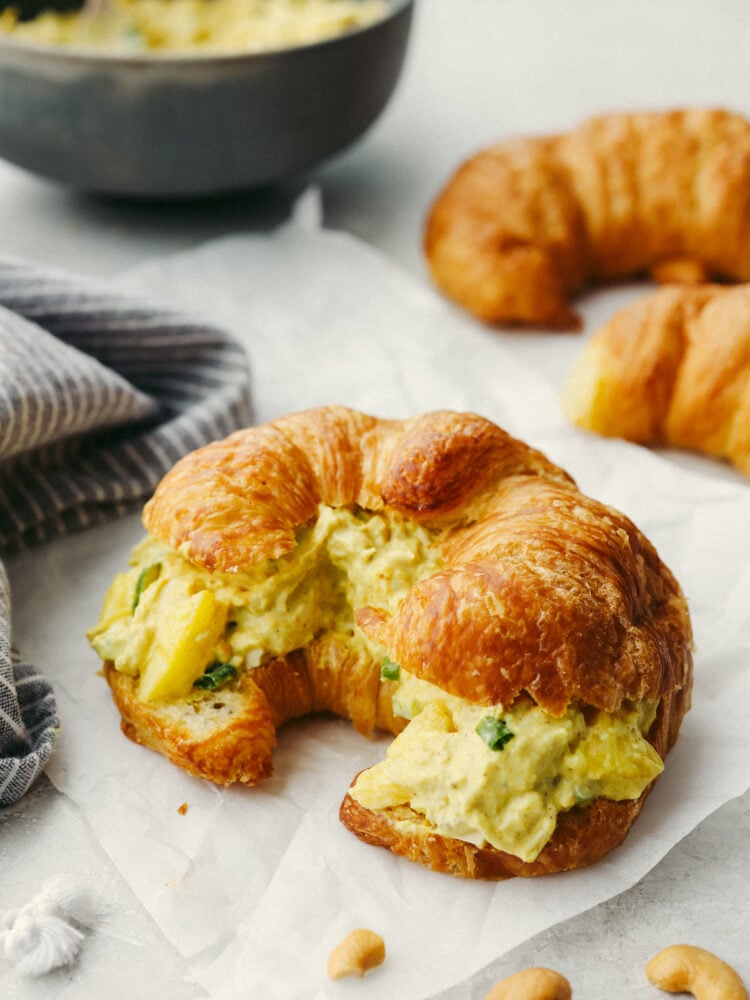The flavor in this curry chicken salad is absolutely incredible! Infused with delicious spices and flavors, this twist on your classic chicken salad recipe is going to blow you away! Curry chicken salad in a croissant.