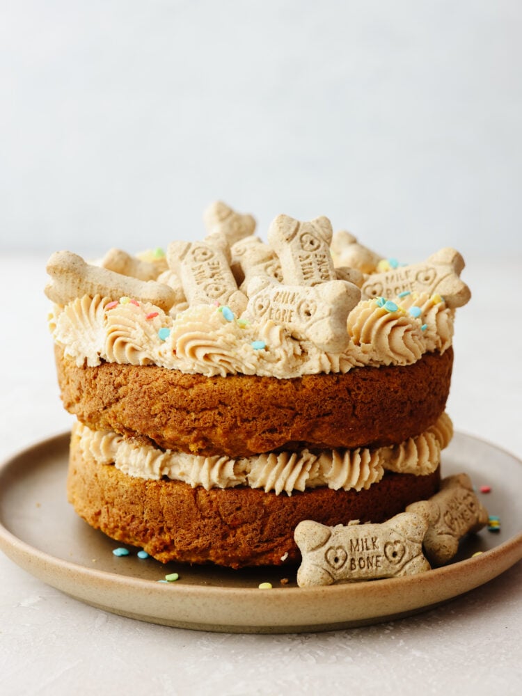 Making your dog a birthday cake is the best way to spoil them on their special day! This furry friend-approved cake is filled with healthy ingredients like yogurt, pumpkin, applesauce and carrots! They’ll love every bite! A whole dog birthday cake topped with dog treats.