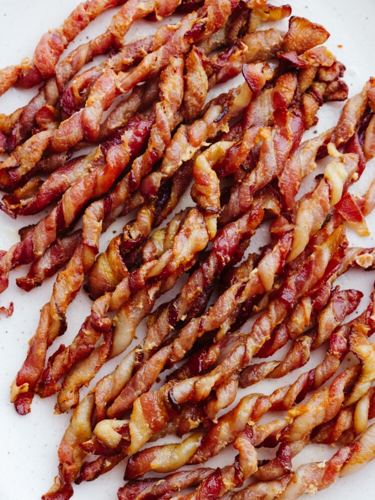 Twisted bacon is beyond easy to make and I love that it's mess-free! Pan-frying bacon can be a little tedious, that's why this method and using an air fryer are my new go-tos! It makes preparing breakfast a breeze. Closeup of cooked bacon.