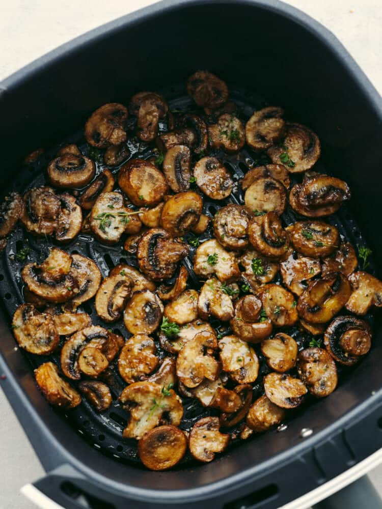 Confession: I never thought I liked mushroomsโฆ until I made these air fryer mushrooms. With garlic parmesan, theyโre juicy, tender, and downright addictive. Even the mushroom skeptics at your table will be fighting over the last bite! Air fryer mushrooms cooked in the bottom of the basket.