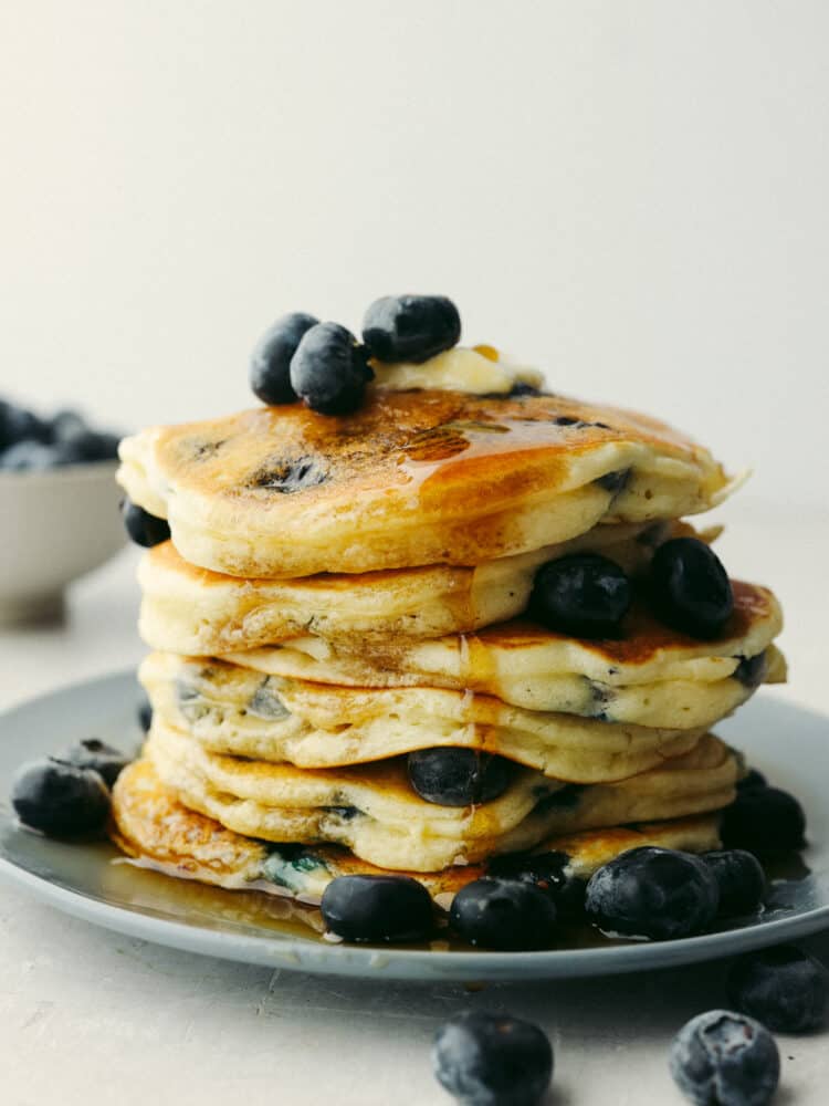 Blueberry pancakes are a classic breakfast option for a good reason... They are the best! Soft, fluffy, and packed with fresh, juicy blueberries, you won't be able to stop at just one! A stack of blueberry pancakes with fresh blueberries on top.