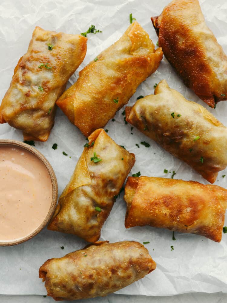 Cheeseburger eggrolls have all the beefy, cheesy goodness of a burger but inside a crispy shell! Make this delicious appetizer for your next get-together and I assure you, it will be a huge hit! Top-down view of whole cheeseburger eggrolls.