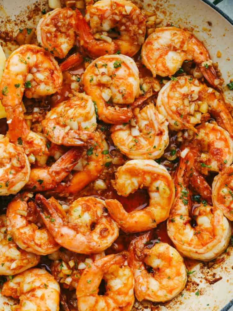 Hawaiian-style garlic shrimp is cooked up in a dreamy garlic butter sauce. Inspired by the food trucks in Hawaii, the punch of savory flavor in each bite will have you feeling like you're on vacation! Closeup of Hawaiian-style garlic shrimp.