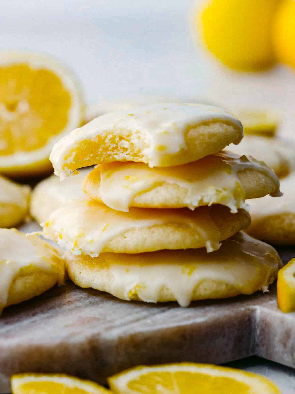 These lemon ricotta cookies are a lemon lover's dream come true! They are soft, moist, and drizzled with amazingly fresh lemon glaze. You will want to serve these up every chance that you get! Side shot of stacked lemon ricotta cookies.