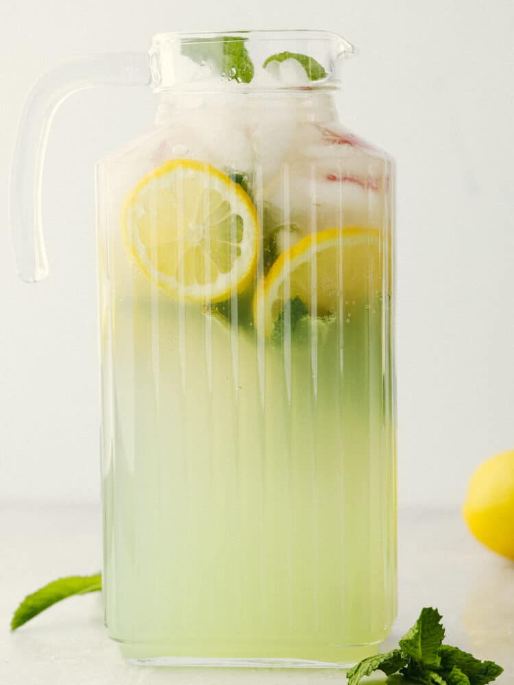 If you are looking for a delightfully refreshing, non-alcoholic drink to get you through all of the hot summer days ahead, this Mint Julep is it! The cool flavorings of mint, cherry, and lemon mix together to create an array of flavors that will satisfy your thirst! A ribbed, clear pitcher filled with mint julep.