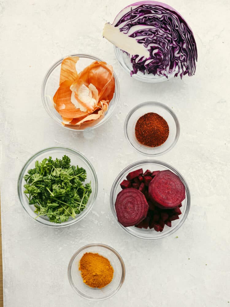 These naturally dyed Easter eggs are such a fun activity for the family! It's amazing to see what colors you can create with basic vegetables and spices! Vegetables and spices in various glass bowls, to be used as dye.